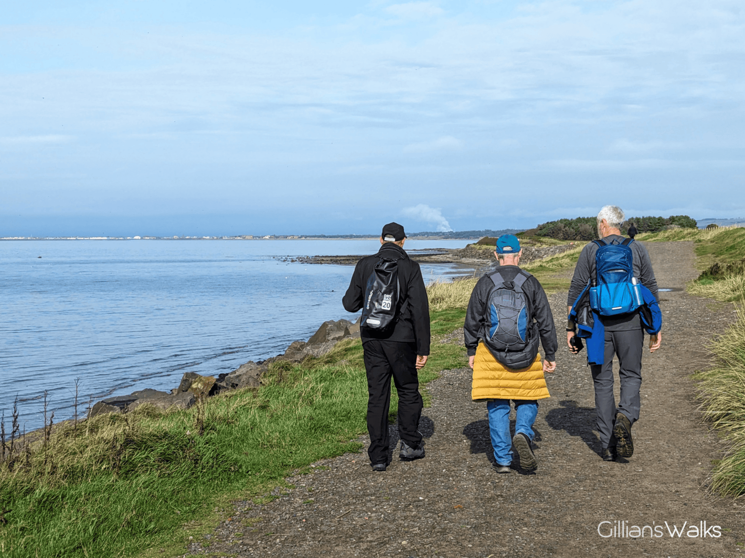 Three men walking along a coastal track between Ayr and Prestwick