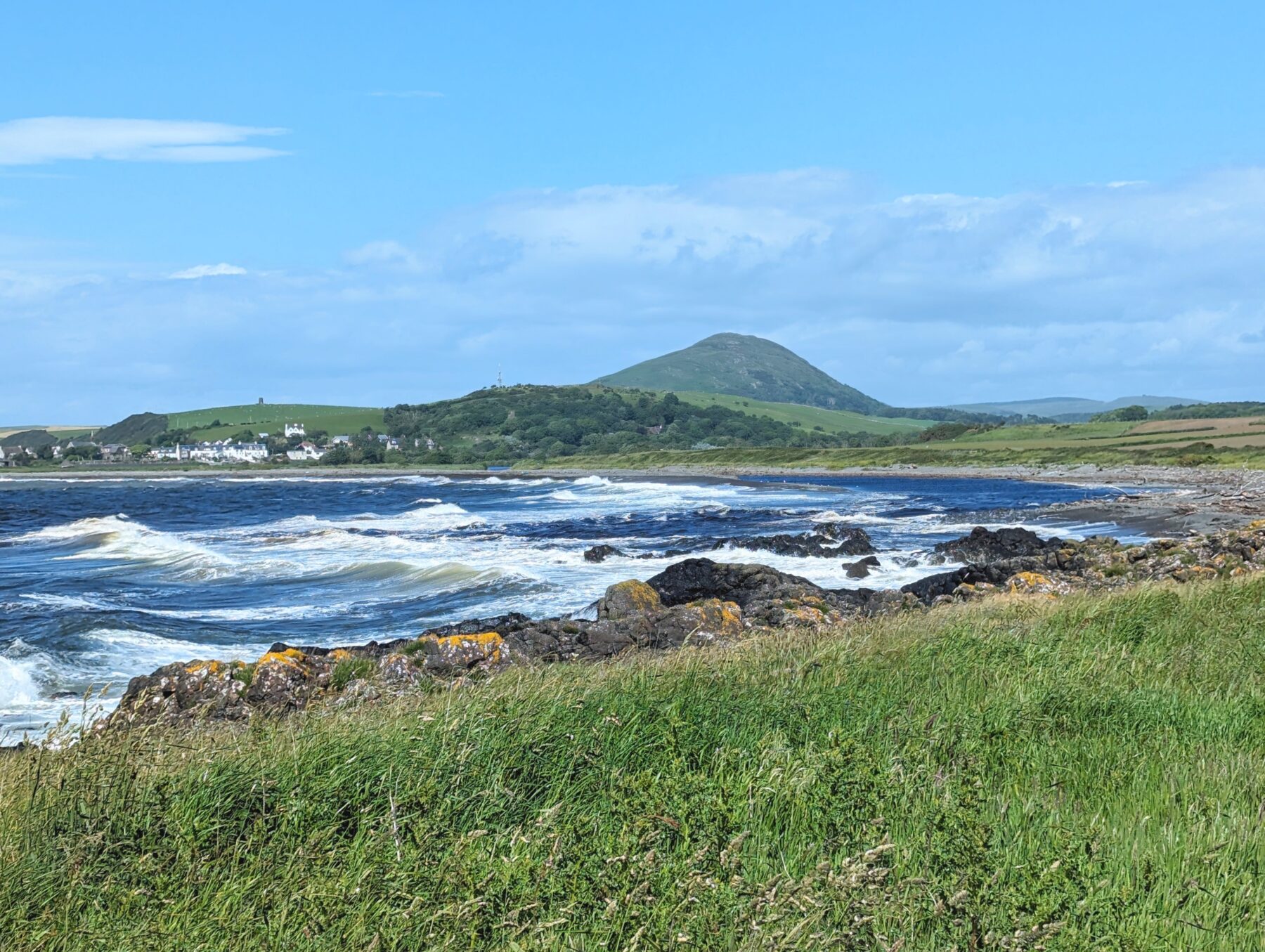 A view across choppy water in Ballantrae Bay,  towards a local hill called Knockdolian
