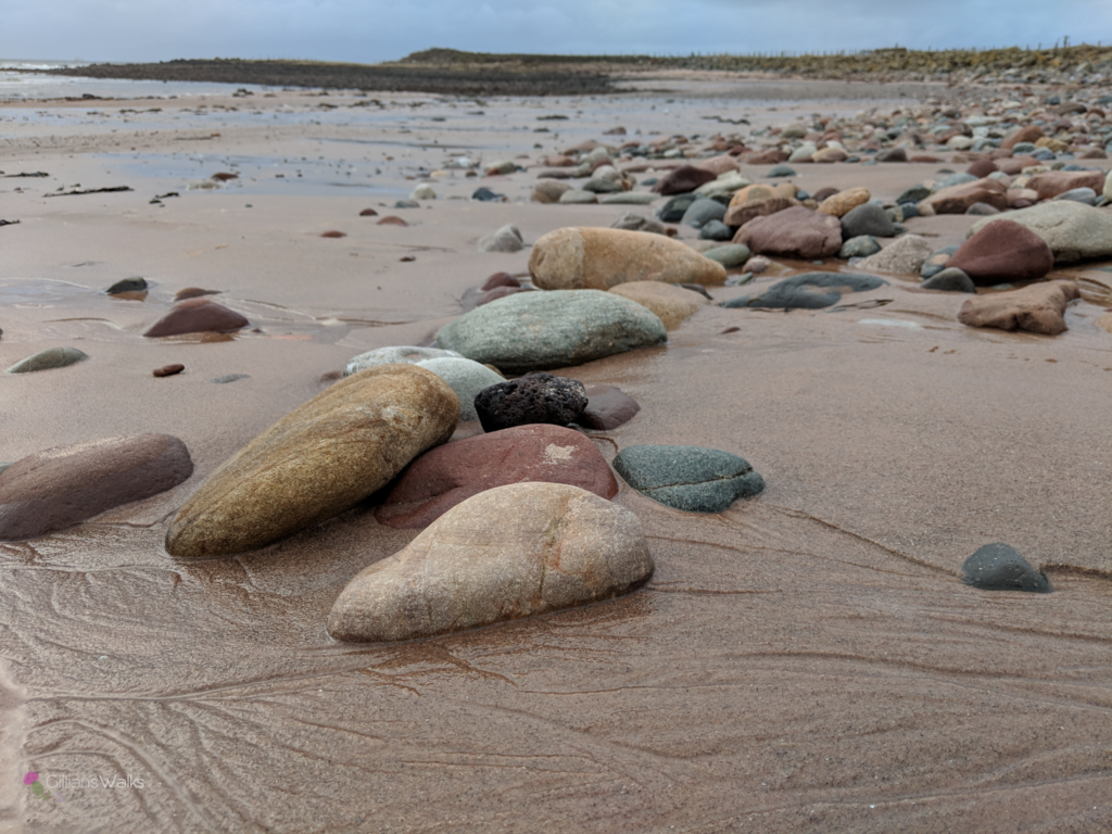Pink sand and pebbles on Ardneil Bay