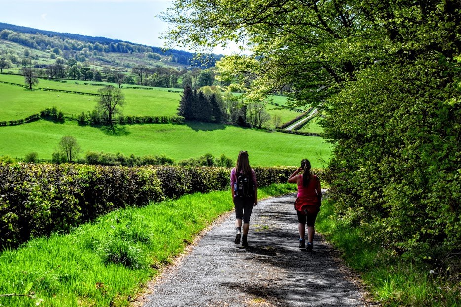 My sister and another lady from the group walking down a single track road out in the Darvel countryside