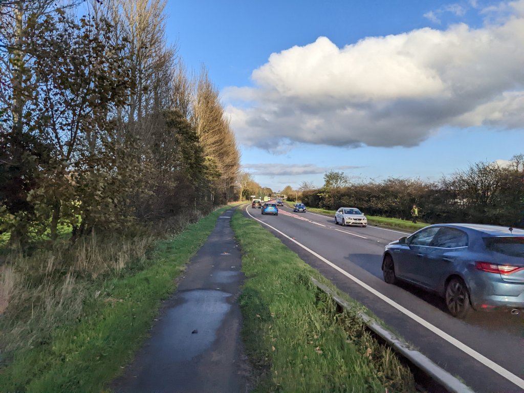 Narrow pavement beside A77 trunk road which is busy with traffic