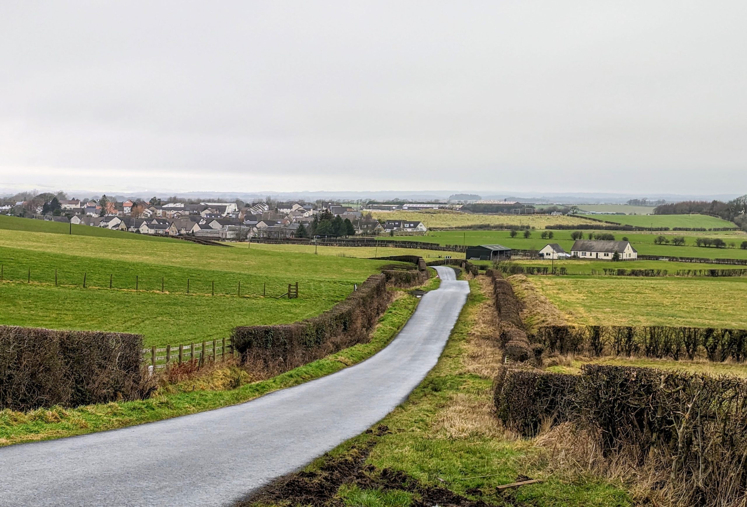 Single track road leading to Dundonald village in the distance