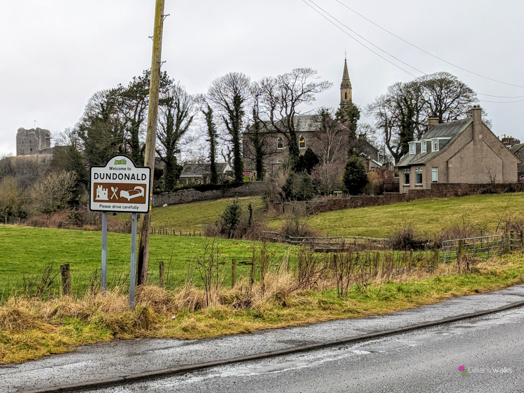 Welcome to Dundonald sign with the village church and castle in the background