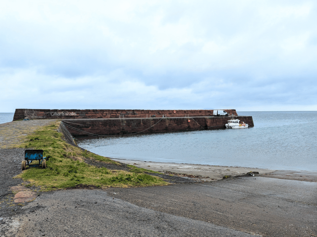 The harbour at Ballantrae with one small fishing boat docked
