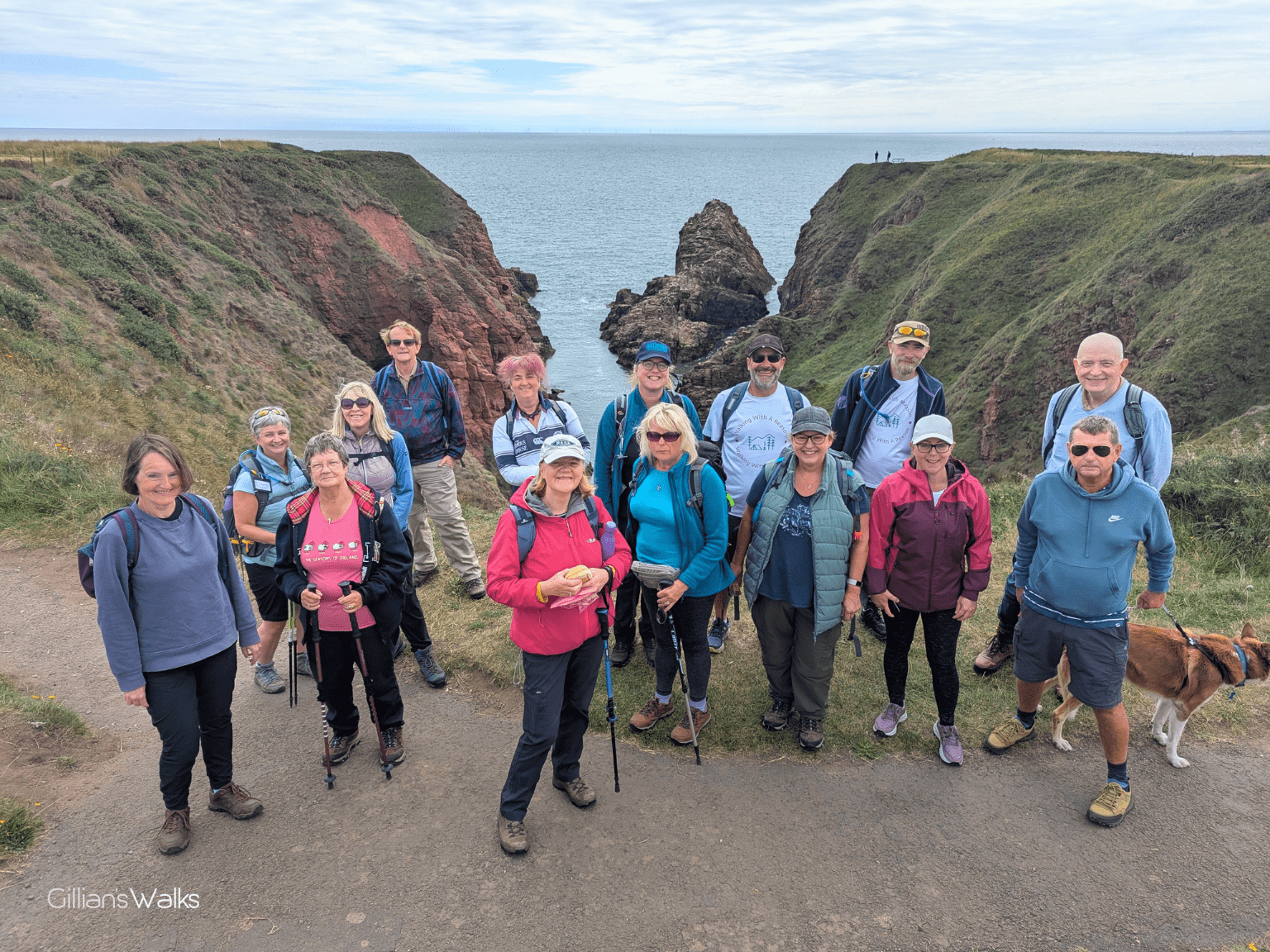 Our group posing on the clifftops with a dramatic view of a deep gorge behind us