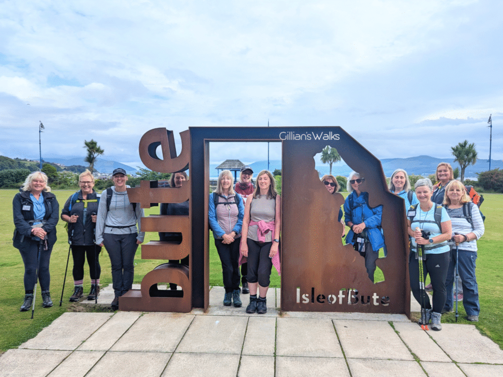 Group posing at the 'bute' sculpture in Rothesay