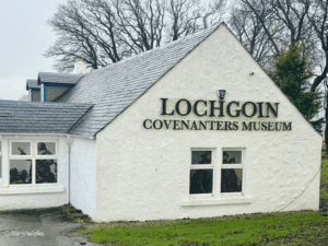 Lochgoin Covenanters Museum exterior - a white farmhouse with prominent signage on the wall.
