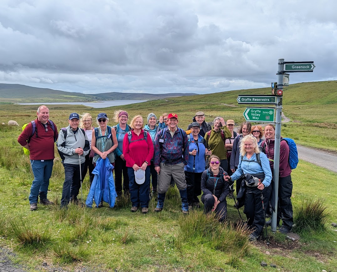 Large walking group posing for a photo at the Gryffe Valley Way signpost