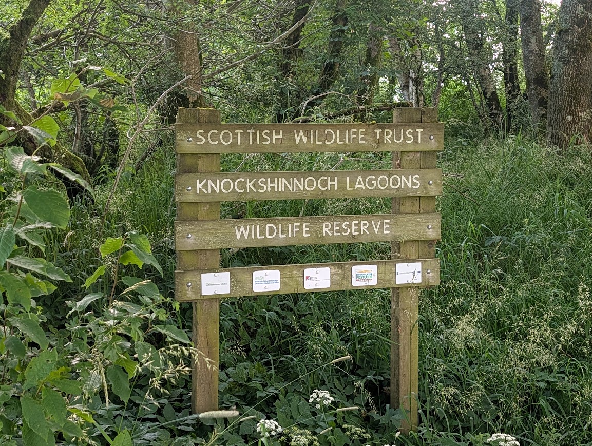 Wooden sign indicating the entrance to the SWT Knockshinnoch Lagoons Wildlife Reserve