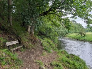 Bench beside a riverside trail in Glen Afton